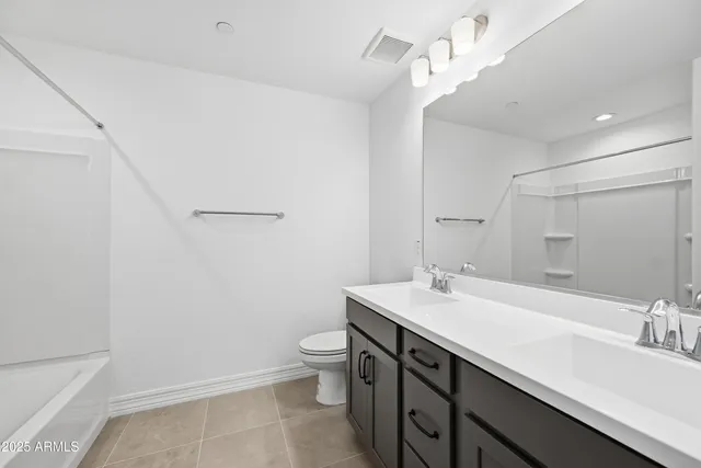 a bathroom with a sink a toilet a mirror and vanity