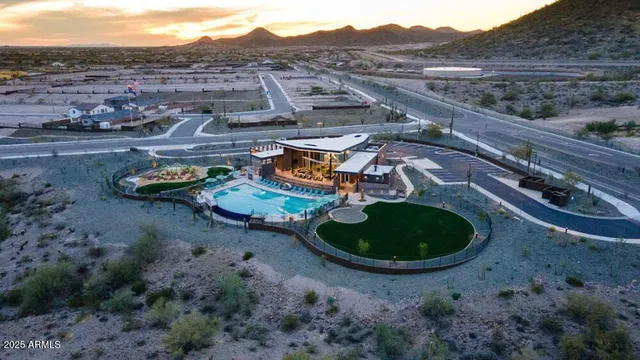 an aerial view of a house with swimming pool and mountain view