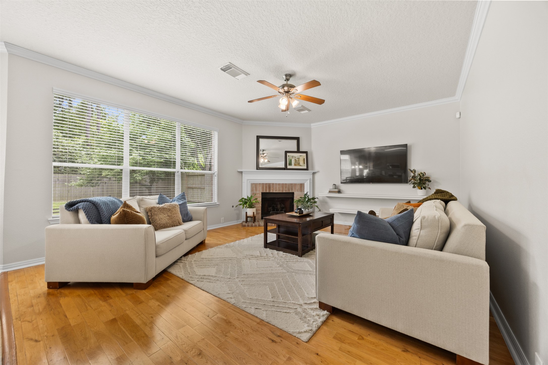 2219 Louetta Brook Lane Spring, TX 77388 - Photo 21 of 34 Bright and comfortable living space featuring crown molding, neutral tones, and an open layout ideal for relaxing or entertaining.