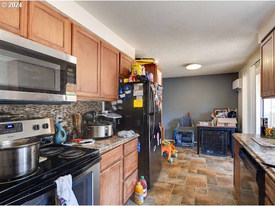 4847-4849 Elderberry Loop Springfield, OR 97478 - Photo 14 of 23 a kitchen with a stove and a microwave