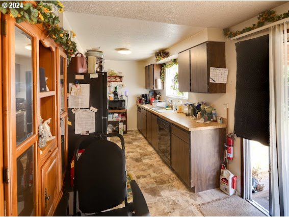 4847-4849 Elderberry Loop Springfield, OR 97478 - Photo 19 of 23 a kitchen with stainless steel appliances kitchen island granite countertop a refrigerator and a stove top oven