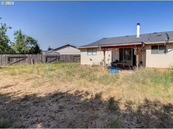 4847-4849 Elderberry Loop Springfield, OR 97478 - Photo 5 of 23 a backyard of a house with yard and outdoor seating