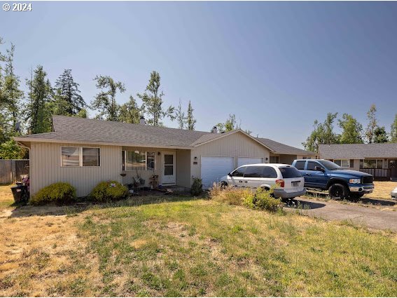 4847-4849 Elderberry Loop Springfield, OR 97478 - Photo 8 of 23 a backyard of a house with table and chairs