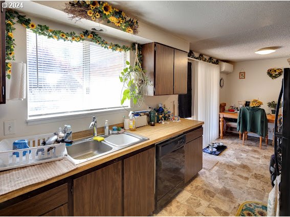 4847-4849 Elderberry Loop Springfield, OR 97478 - Photo 10 of 23 a kitchen with granite countertop a sink stainless steel appliances a counter space and a window