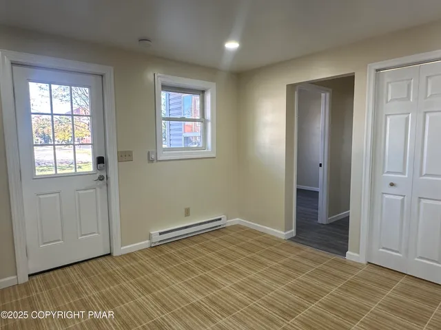 a bathroom with a toilet and a rug