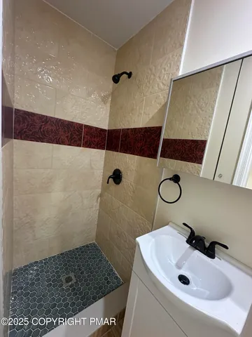 a bathroom with a sink toilet and shower