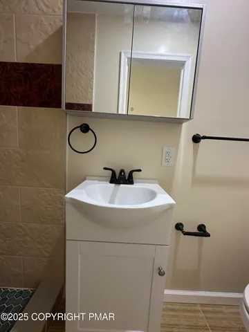 a bathroom with a sink toilet and shower