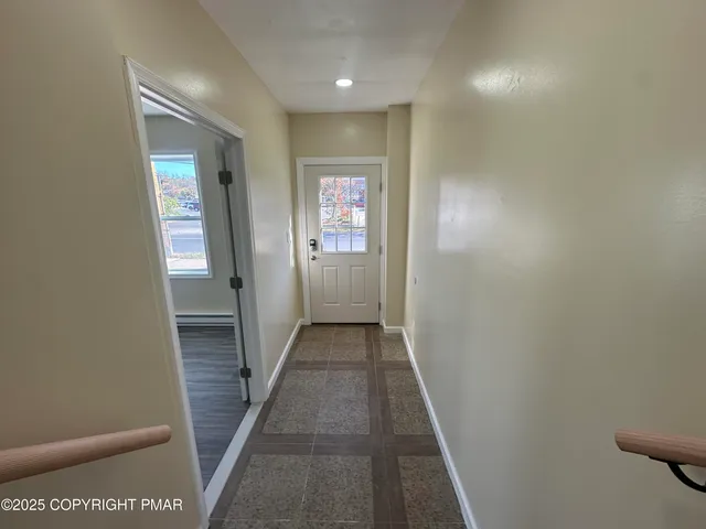 an empty room with windows and closet