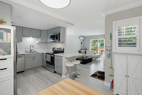 a kitchen with sink cabinets and wooden floor