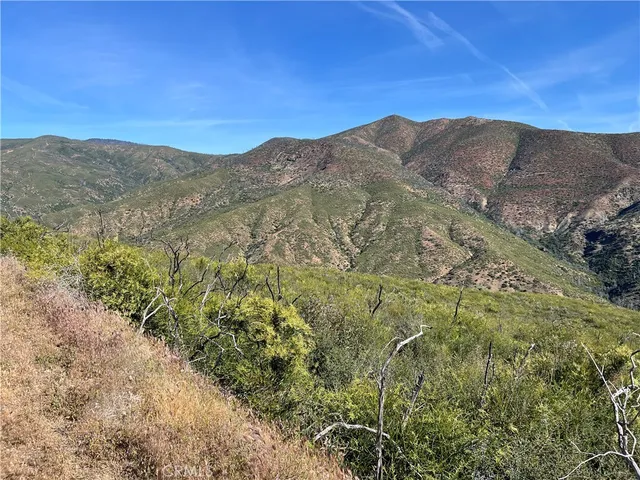 a view of a mountain range in a cloudy sky
