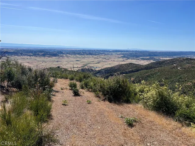 a view of a beach with a mountain in the background