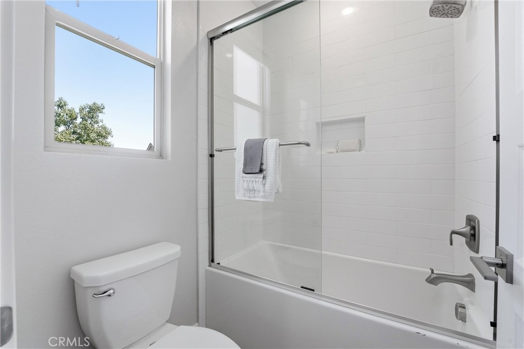 182 Scale Irvine, CA 92618 - Photo 46 of 61 Full tub, subway tile surround, glass slider, and natural light from a corner window. A complete bath that pulls its weight.