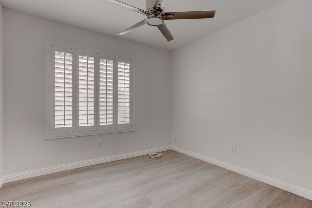1416 Walstone Road North Las Vegas, NV 89031 - Photo 20 of 47 A well-lit bedroom features durable laminate flooring and practical plantation shutters.