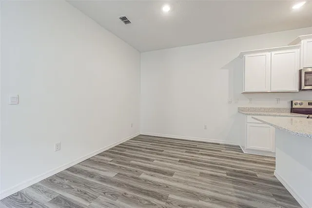 a kitchen with stainless steel appliances a refrigerator sink and microwave