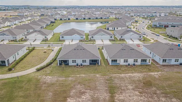 an aerial view of residential houses with outdoor space