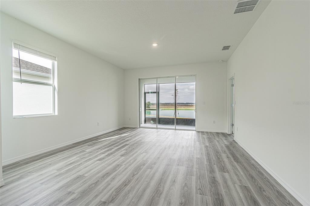 31415 Paper Birch Street Wesley Chapel, FL 33545 - Photo 9 of 29 an empty room with wooden floor and windows