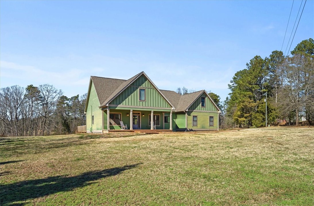 212 Winding Lane Seneca, SC 29672 - Photo 2 of 47 This charming residence offers a spacious front yard and a welcoming porch, perfect for relaxation.