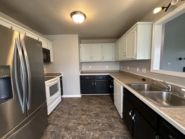 a kitchen with a sink stove and refrigerator