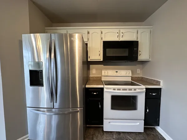 a kitchen with a stove microwave and refrigerator