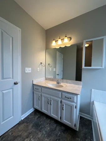 a spacious bathroom with a double vanity sink and a mirror