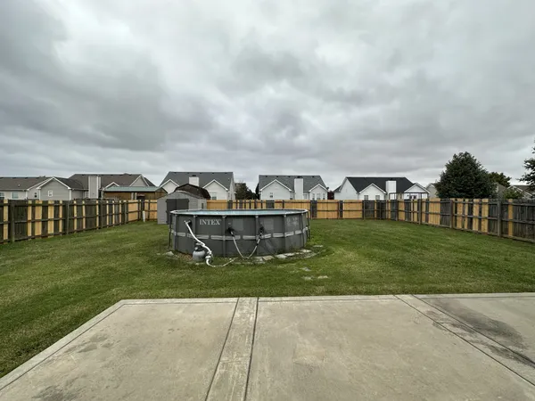 a view of a house with a yard and sitting area