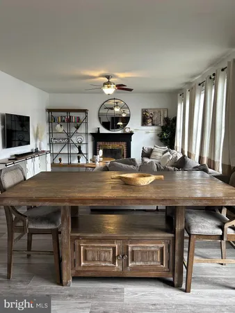 a kitchen with a stove a microwave a dining table and chairs