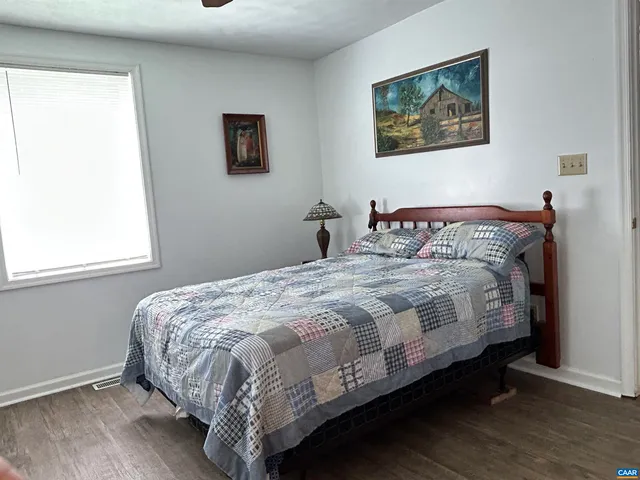 a bedroom with a bed window and a table