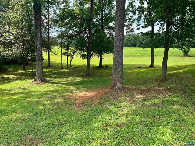 a view of a kitchen with stainless steel appliances a stove a sink and cabinets