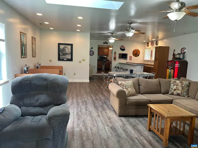 a kitchen with stainless steel appliances a kitchen island a microwave a stove and refrigerator