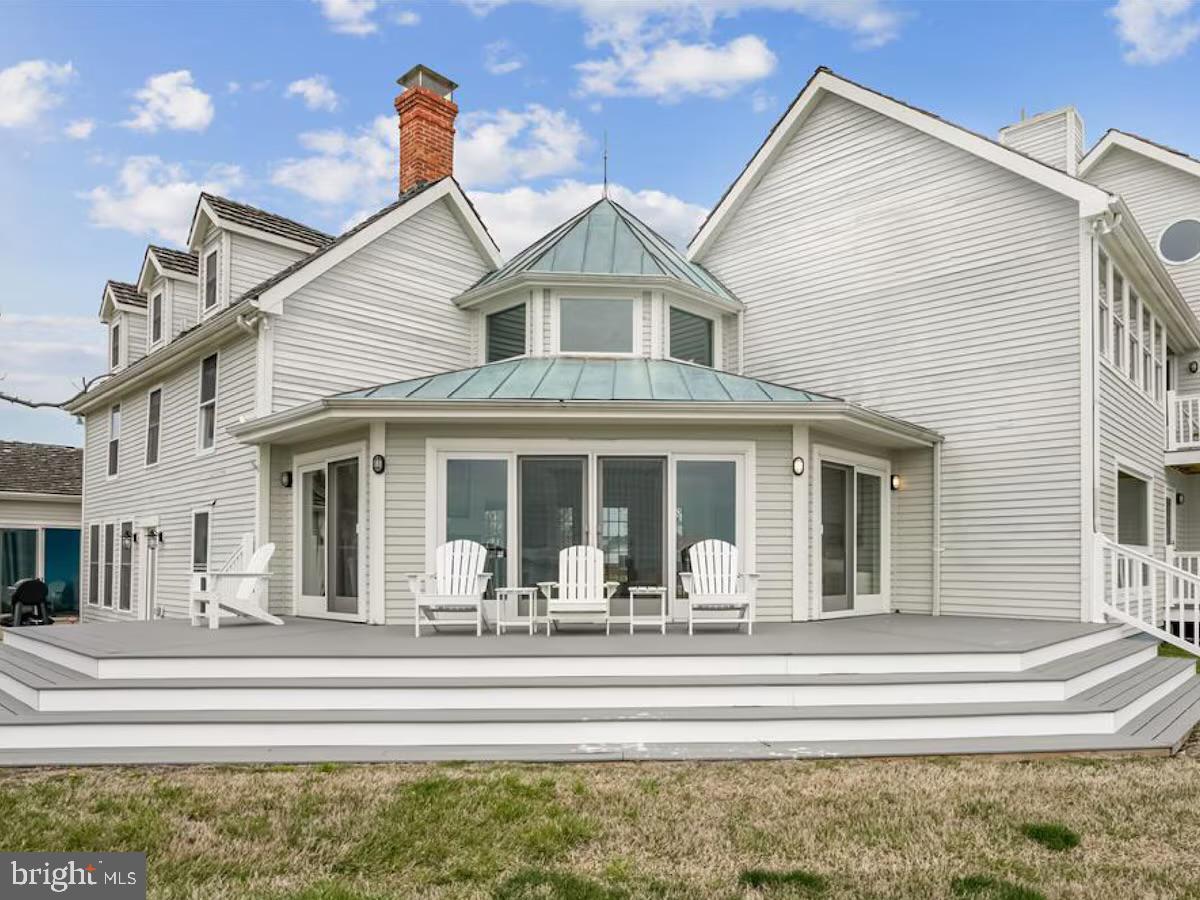 21642 Chicken Point Road Tilghman, MD 21671 - Photo 59 of 63 a view of a white house with a large windows and couches