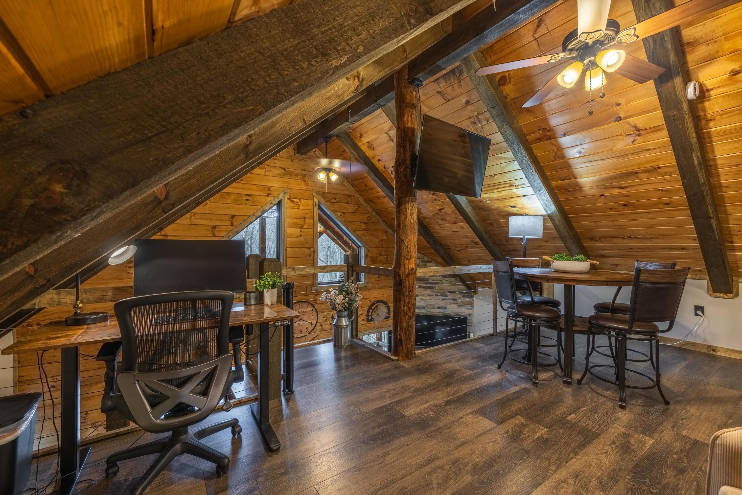 344 Skaggs Road Londonderry, OH 45647 - Photo 15 of 57 Sage Hill Escape upstairs loft with 2 full size beds, high top table and chairs, and workspace
