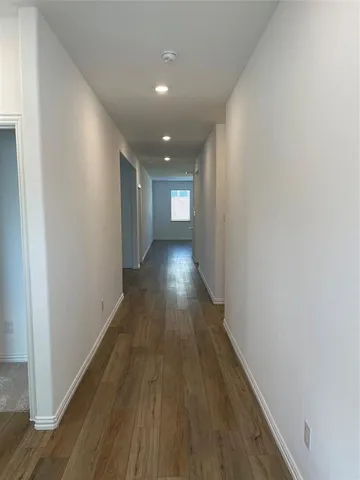 a view of gallery with wooden floor