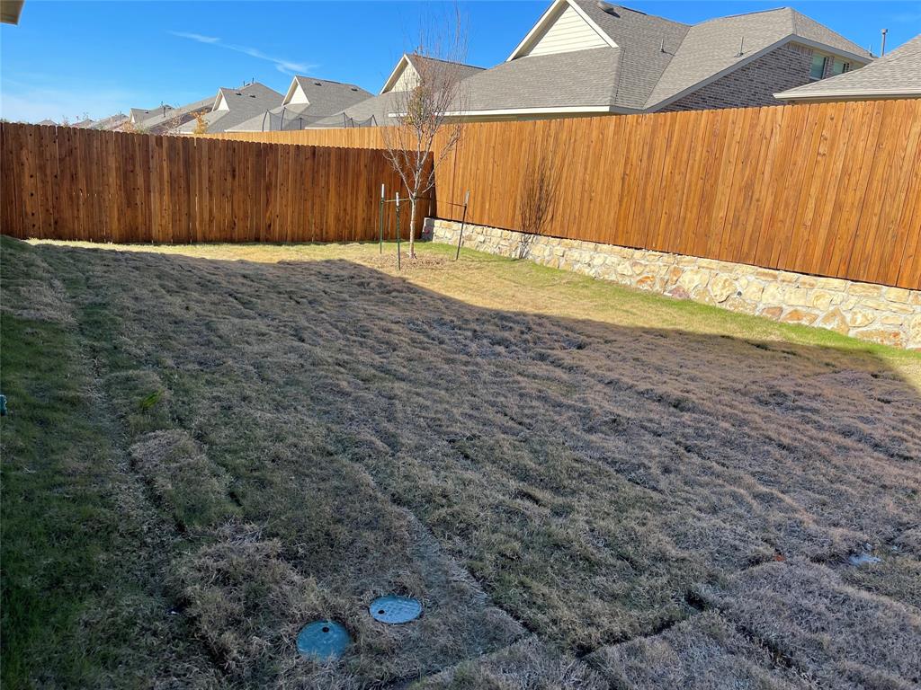 1204 Sequoia Lane Princeton, TX 75407 - Photo 20 of 20 a view of a backyard with wooden fence