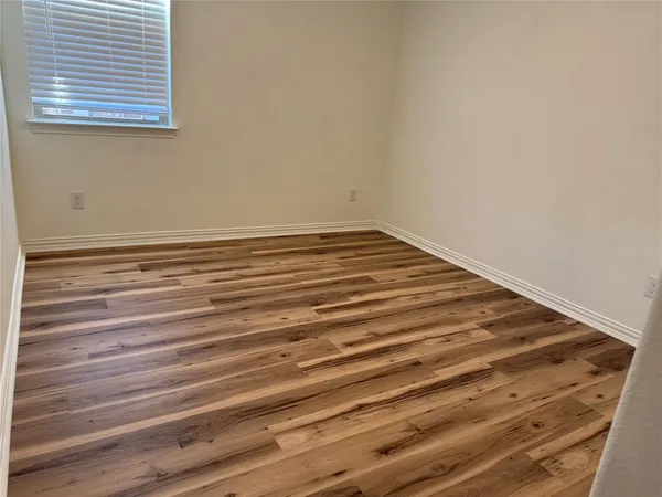 a view of a room with wooden floor and cabinet