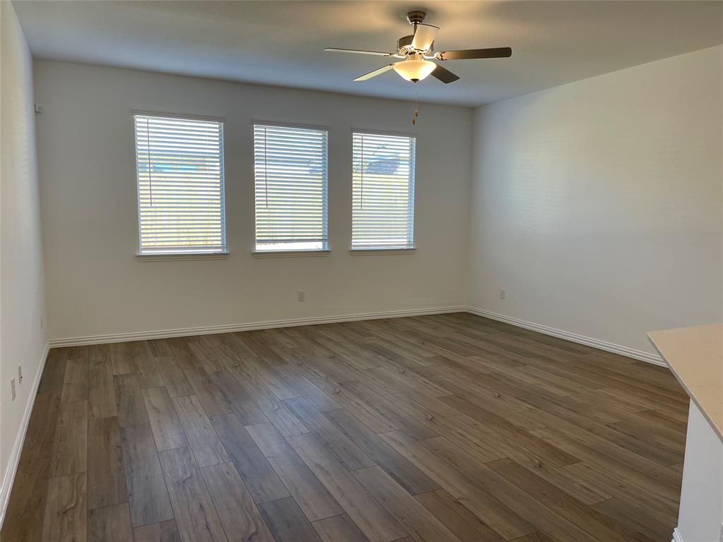 1204 Sequoia Lane Princeton, TX 75407 - Photo 7 of 20 wooden floor in an empty room with a window