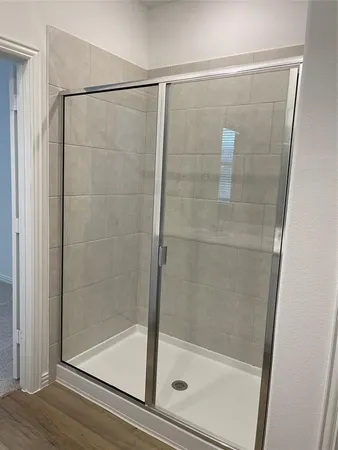 a bathroom with a glass shower door