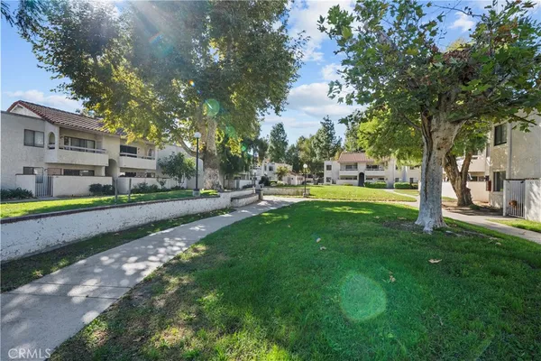 a view of yard with swimming pool and green space