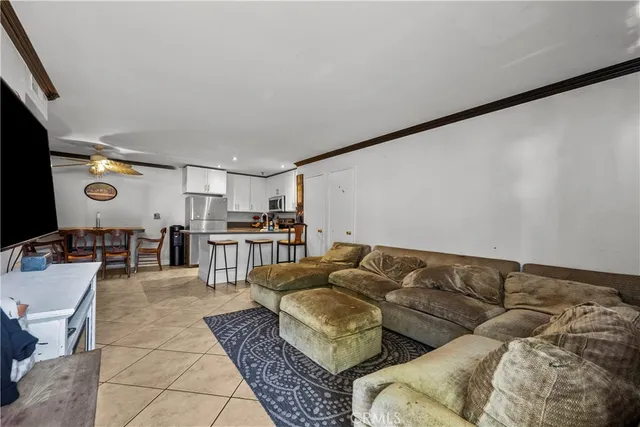 a living room with furniture and kitchen view