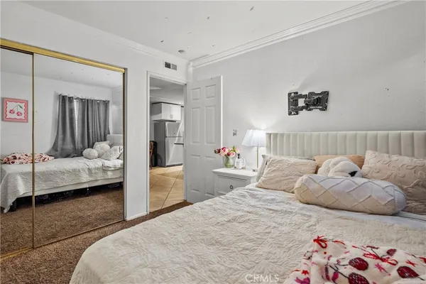 a bedroom with a bed and a couch
