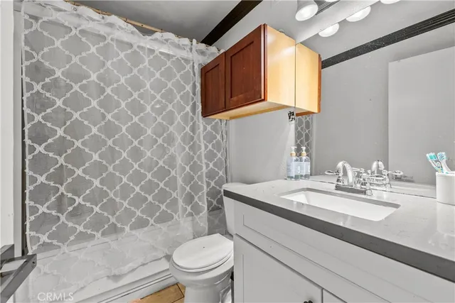 a bathroom with a sink toilet and mirror