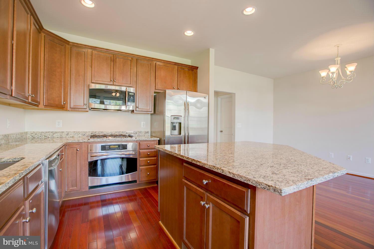 141 Short Branch Road Stafford, VA 22556 - Photo 12 of 30 a kitchen with stainless steel appliances granite countertop a stove a sink and a refrigerator