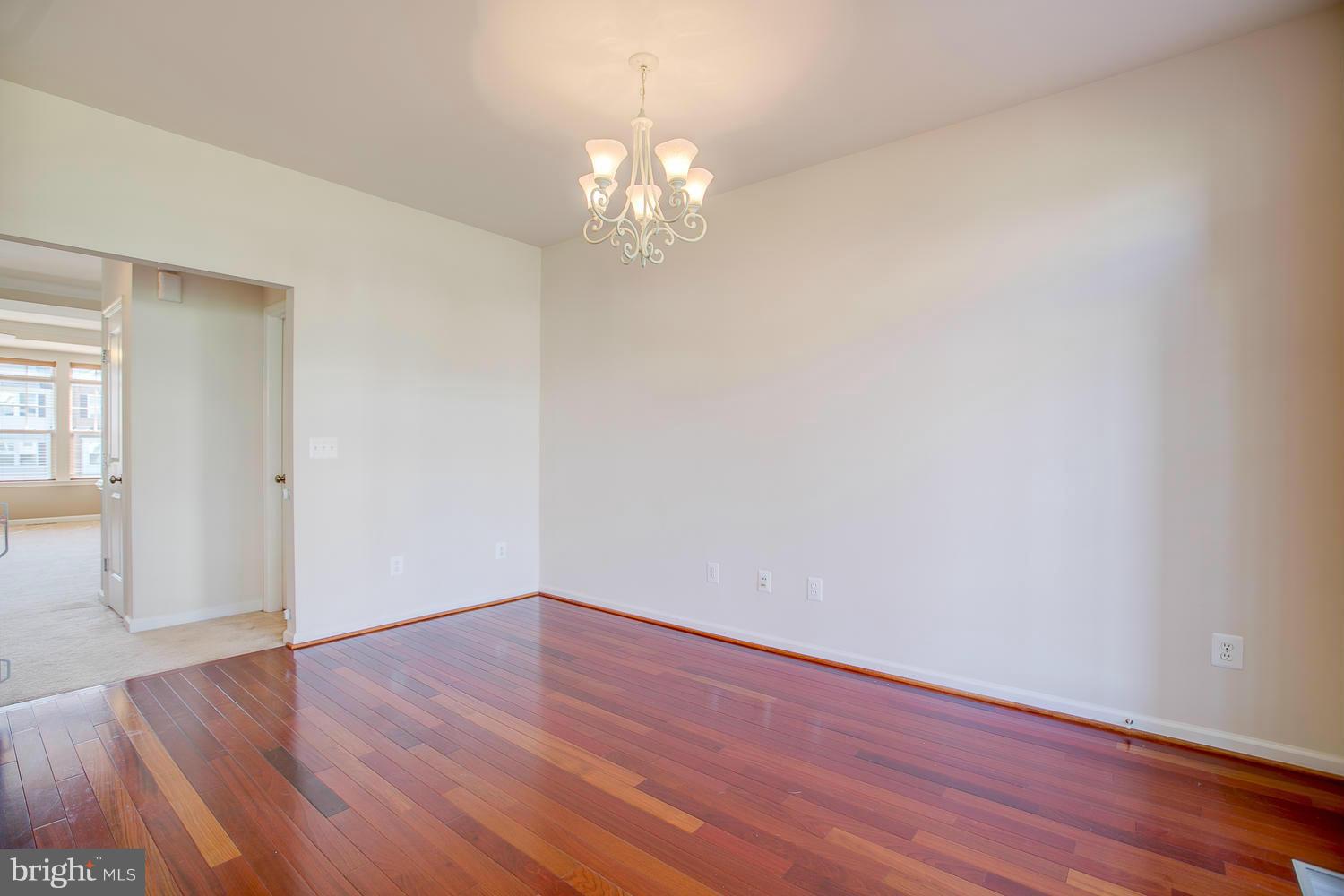 141 Short Branch Road Stafford, VA 22556 - Photo 7 of 30 a view of a hallway with wooden floor and a chandelier