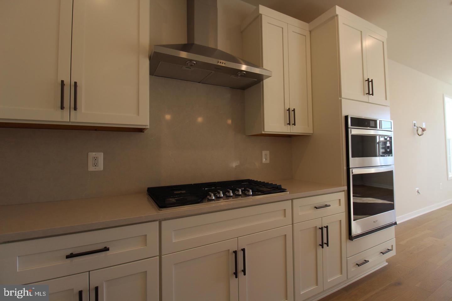 22383 Roanoke Rise Terrace Ashburn, VA 20148 - Photo 12 of 41 a kitchen with white cabinets and black appliances