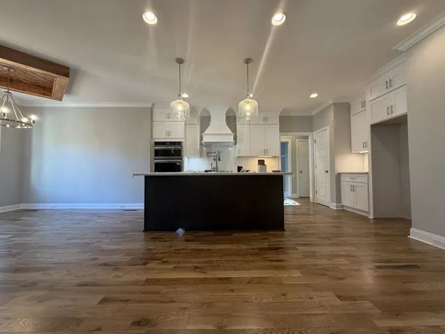 a view of kitchen with kitchen island stainless steel appliances refrigerator and cabinets