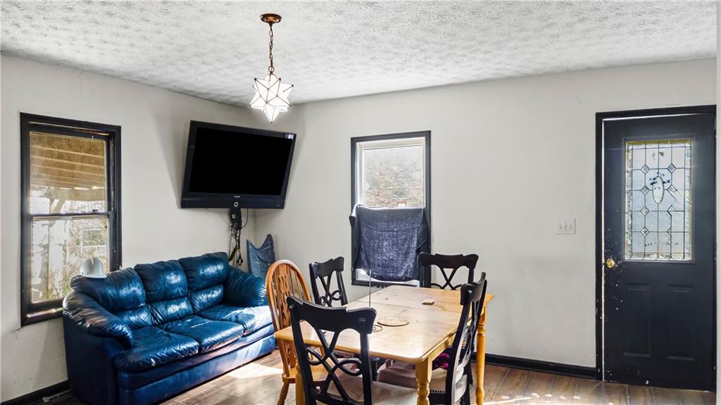 5 Ivy Street Canton, GA 30114 - Photo 11 of 27 a living room with furniture and a flat screen tv