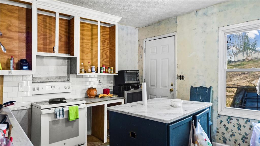 5 Ivy Street Canton, GA 30114 - Photo 14 of 27 a kitchen that has a cabinets and a stove