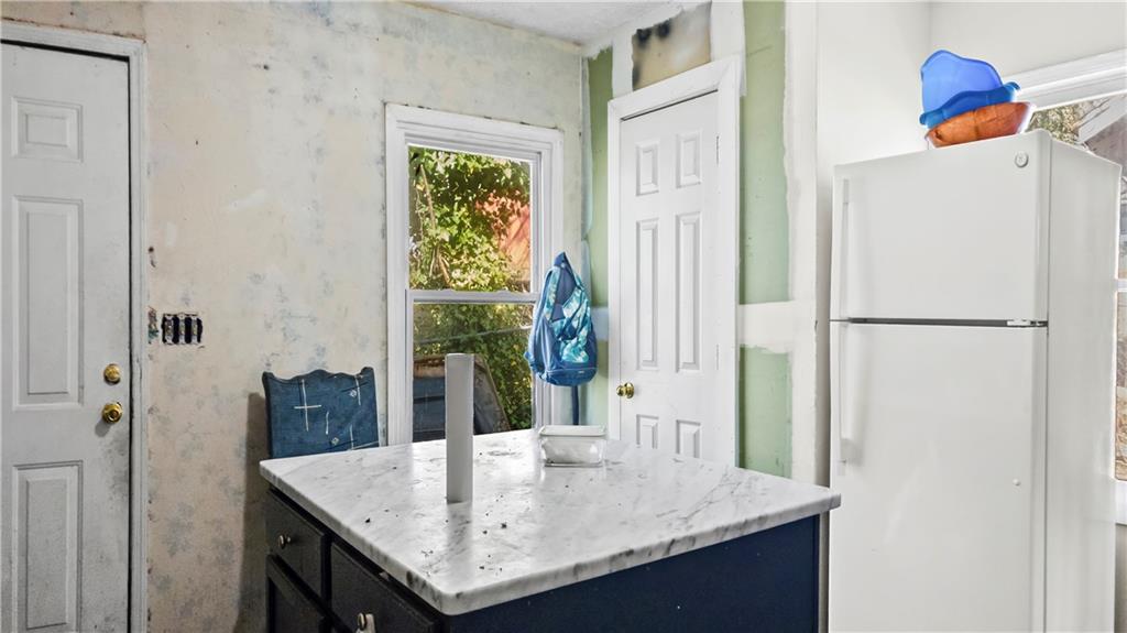 5 Ivy Street Canton, GA 30114 - Photo 16 of 27 a kitchen with a refrigerator and a table