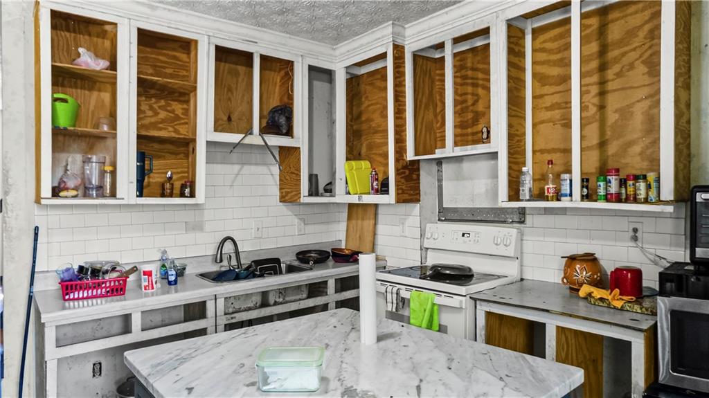 5 Ivy Street Canton, GA 30114 - Photo 17 of 27 a kitchen with stainless steel appliances a stove and a sink