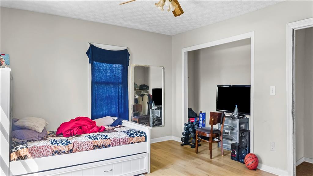 5 Ivy Street Canton, GA 30114 - Photo 19 of 27 a bedroom with a bed and a potted plant