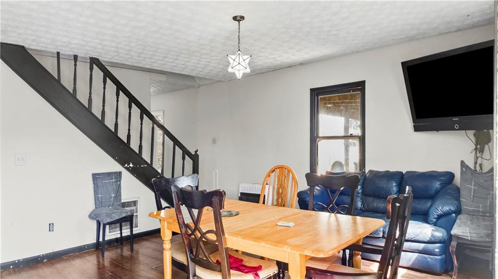 5 Ivy Street Canton, GA 30114 - Photo 9 of 27 a view of a dining room with furniture a chandelier and wooden floor